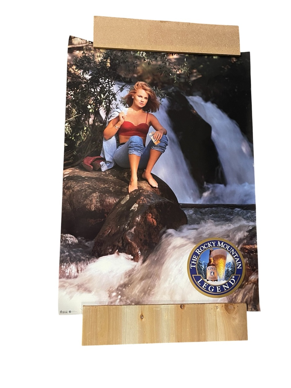 The Rocky Mountain Legend Poster - Woman by Waterfall - 28” x 20”